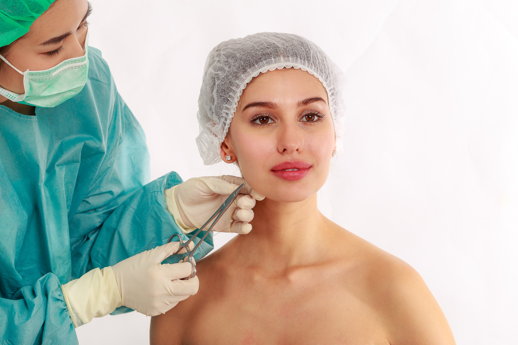 Beautiful young woman gets PDO Suture operation, face lifting surgery in the cosmetology salon